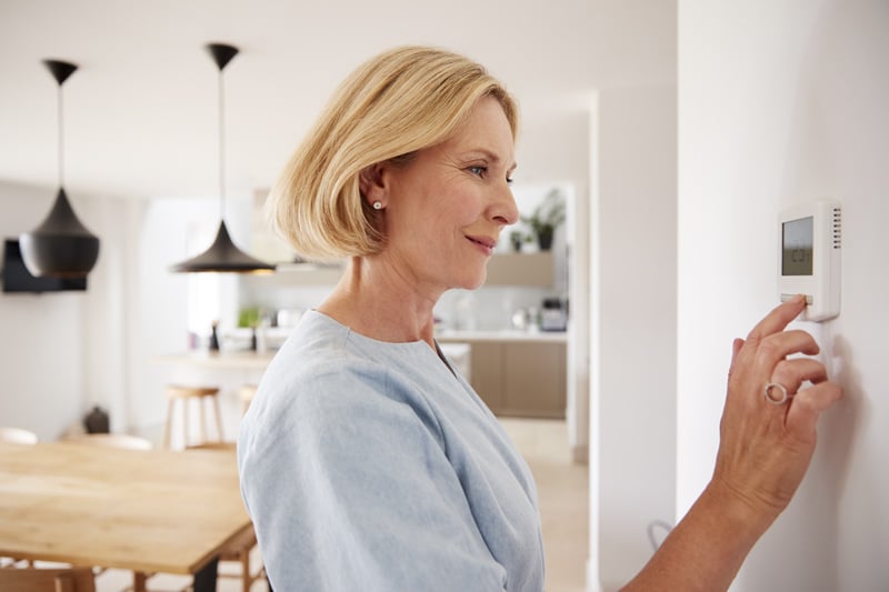 woman-adjusting-air-con