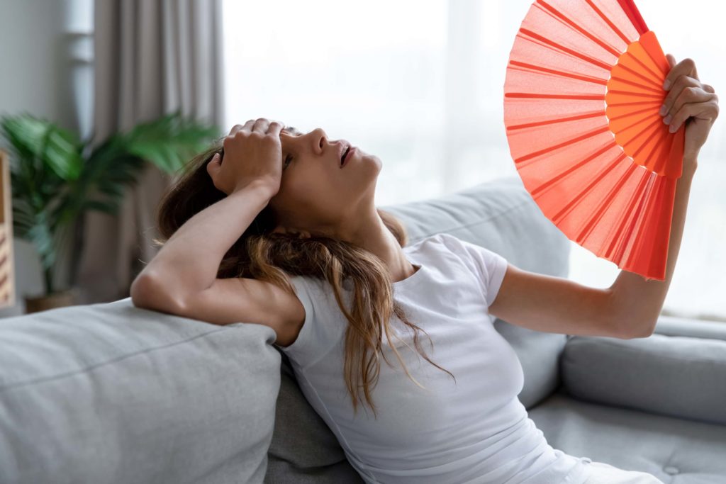 Woman in home without ducted air conditioning